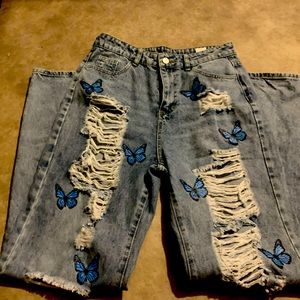 Ripped jeans with butterflies on them